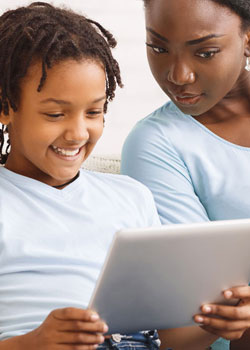 mother and child looking at a tablet