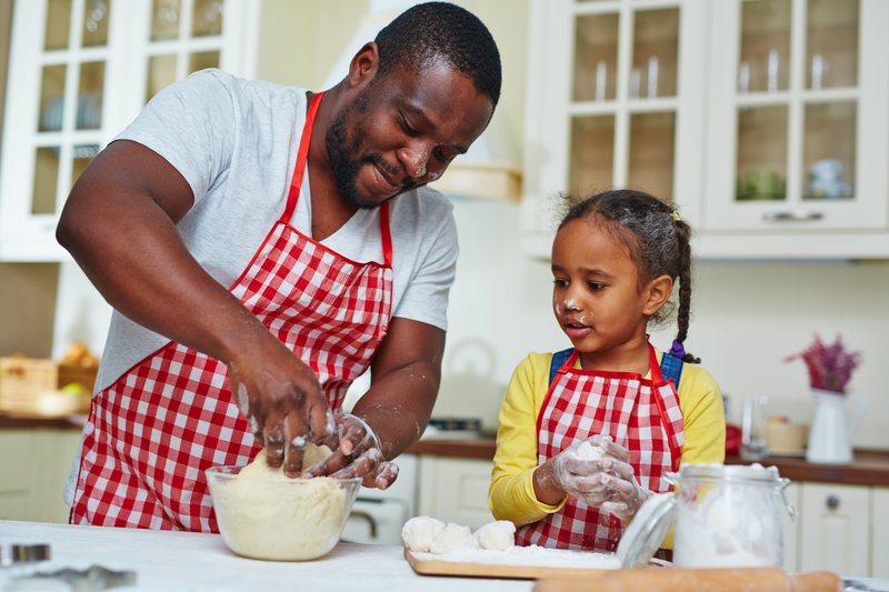 man and child cooking in a kitchen