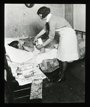 Nurse helping a patron from the Nurse Lantern Slides