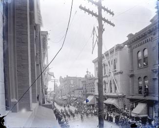 Parade coming down 5th Ave between Church and Union, in 1897