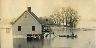 View of house, people during a flood, 1913