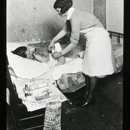 Nurse helping a patron from the Nurse Lantern Slides